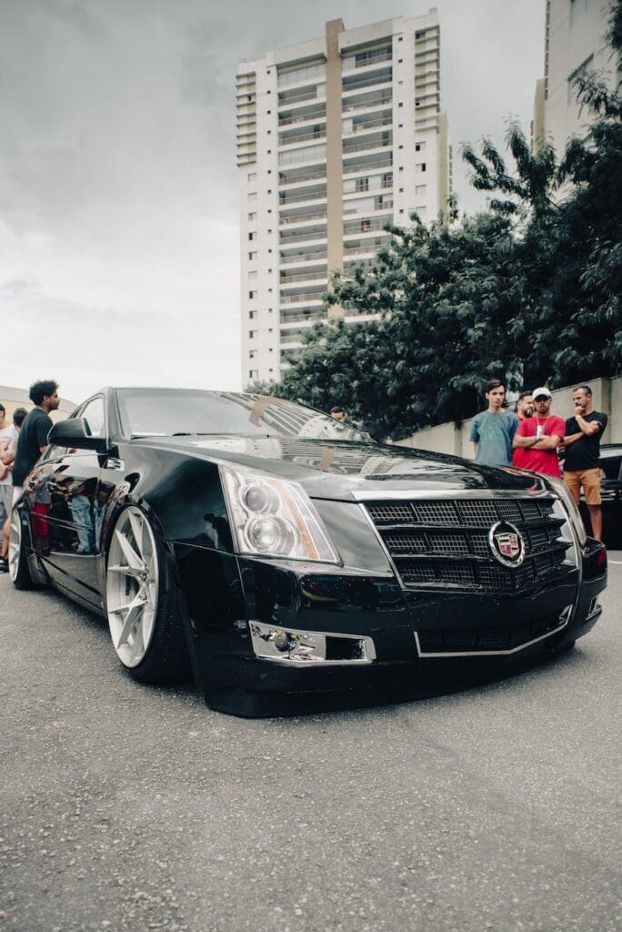 black cadillac car parked on the road